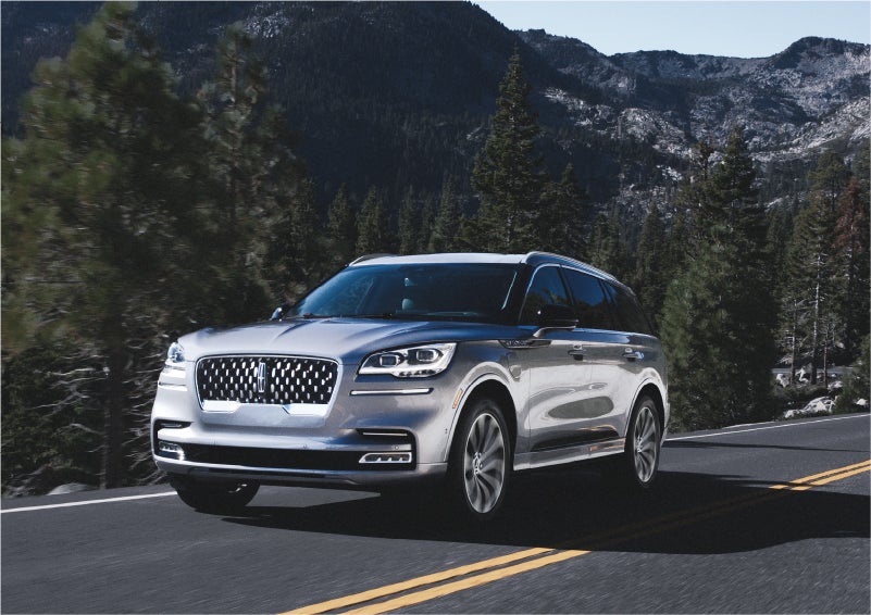 A 2023 Lincoln Aviator® Grand Touring SUV being driven on a winding road to demonstrate the capabilities of all-wheel drive | Caruso Lincoln in Long Beach CA