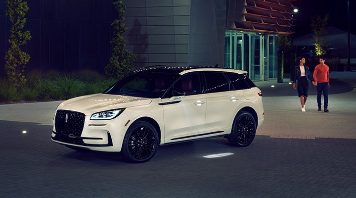 Two people approach a 2024 Lincoln Corsair® SUV featuring the available Jet Appearance Package. | Caruso Lincoln in Long Beach CA