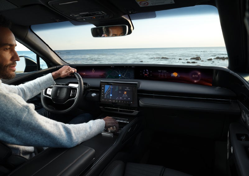 A driver of a parked 2025 Lincoln Nautilus® SUV takes a relaxing moment at a seaside overlook while inside his Nautilus. | Caruso Lincoln in Long Beach CA