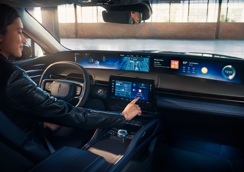 The driver of a 2025 Lincoln Nautilus® SUV interacts with the center touchscreen. | Caruso Lincoln in Long Beach CA