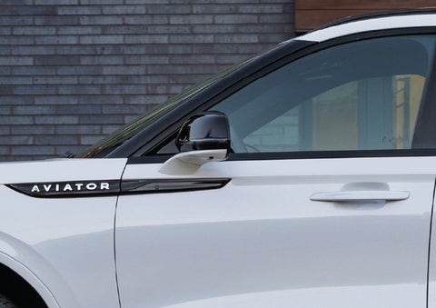 The driver’s side door and fender badging of a white 2026 Lincoln Aviator® SUV are showcased. | Caruso Lincoln in Long Beach CA