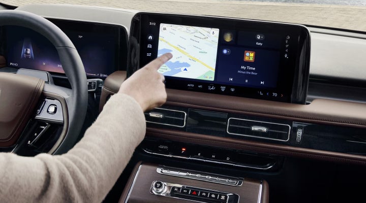 A person is tapping the center display touchscreen of a 2026 Lincoln Aviator® SUV. | Caruso Lincoln in Long Beach CA