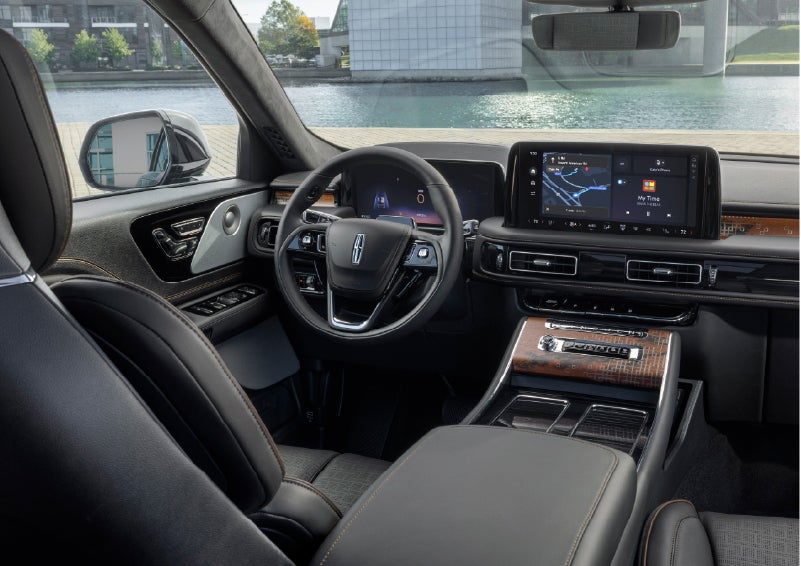 The interior of the 2026 Lincoln Aviator® SUV is shown parked with a view of a harbor through the windshield. | Caruso Lincoln in Long Beach CA