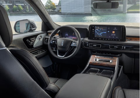 The interior of the 2026 Lincoln Aviator® SUV is shown parked with a view of a harbor through the windshield. | Caruso Lincoln in Long Beach CA