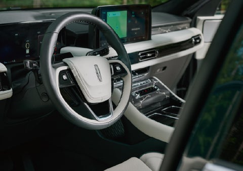 The leather-trimmed steering wheel of a 2027 Lincoln Aviator® Black Label™ SUV. | Caruso Lincoln in Long Beach CA
