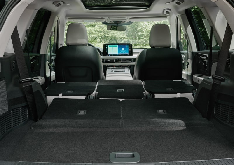 A rear to front view of the interior of a 2027 Lincoln Aviator® Black Label™ SUV shows the third and second rows folded flat | Caruso Lincoln in Long Beach CA