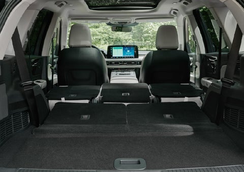 A rear to front view of the interior of a 2027 Lincoln Aviator® Black Label™ SUV shows the third and second rows folded flat | Caruso Lincoln in Long Beach CA