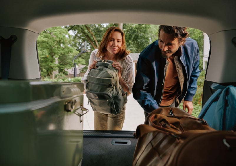 A couple loads luggage into the rear of a 2027 Lincoln Aviator® Black Label™ SUV..e 202 | Caruso Lincoln in Long Beach CA