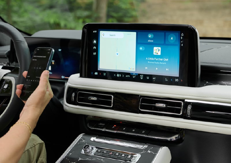 A person pairs thier phone with the center touchscreen of a 2027 Lincoln Aviator® Black Label™ SUV | Caruso Lincoln in Long Beach CA